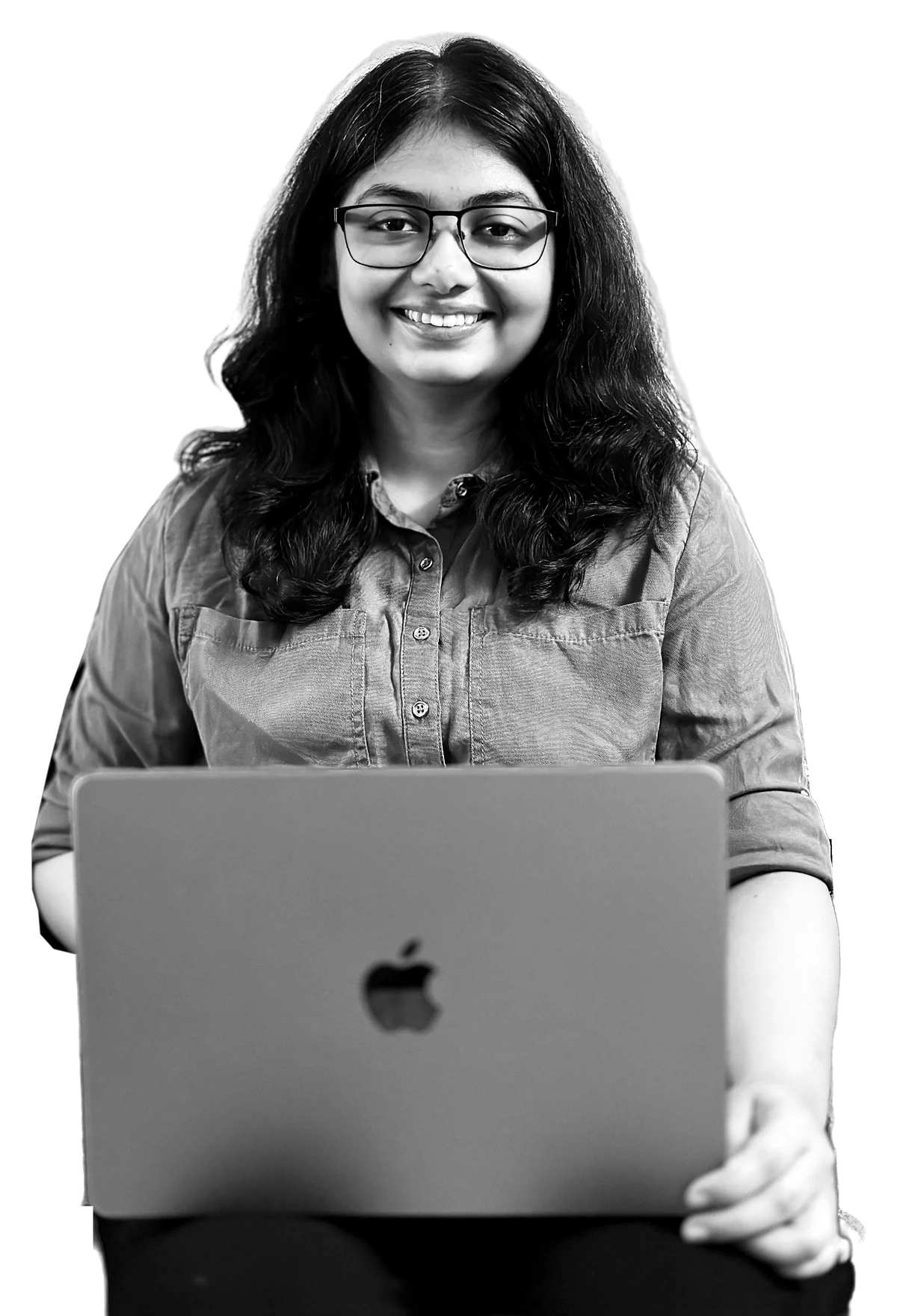 Portrait of Gouri Dixit, seated and working at a laptop.